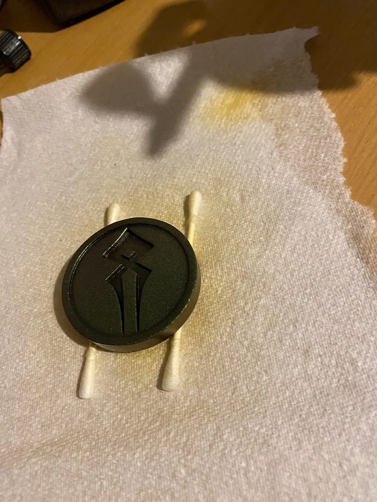 After being primed, the first layr of gold goes on the coin.
