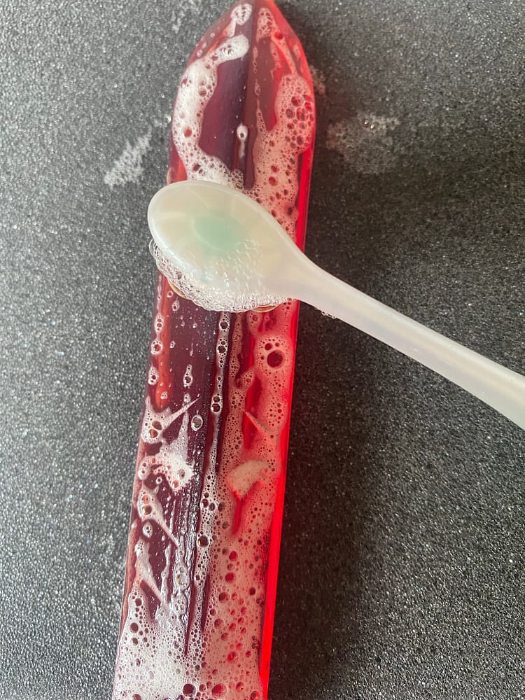 Resin spike being cleaned with a toothbrush