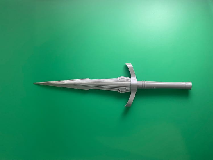 Raw Build loki dagger on a green background.
